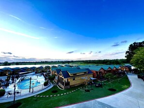 A resort with multiple cabins, a swimming pool, and a well-maintained lawn. - Belas Resort (Willis)