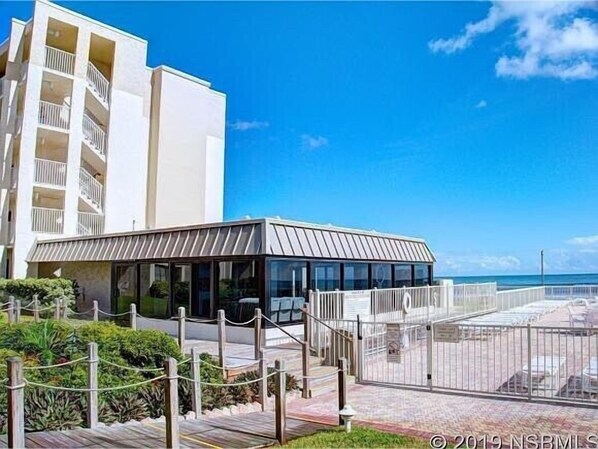 Exterior - Beautifully updated 5th-floor oceanfront condo in Castle Reef, New Smyrna Beach. Enjoy stunning ocean, pool, and courtyard views. Community perks include a beachfront pool, gazebo, grills, and more—perfect for a relaxing beach getaway! (New Smyrna Beach)