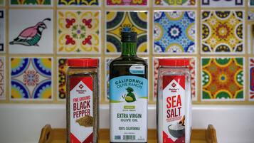 Three containers of spices on a wooden tray.