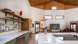 A spacious kitchen with a large island, wooden cabinets, and a tiled backsplash. - Hummingbird Hacienda - Los Ojos Cabin w/ Brazos Cliff Views (Los Ojos)