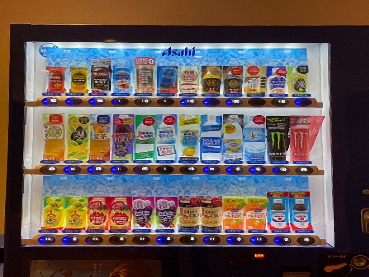 A vending machine with multiple rows of colorful packaged drinks.