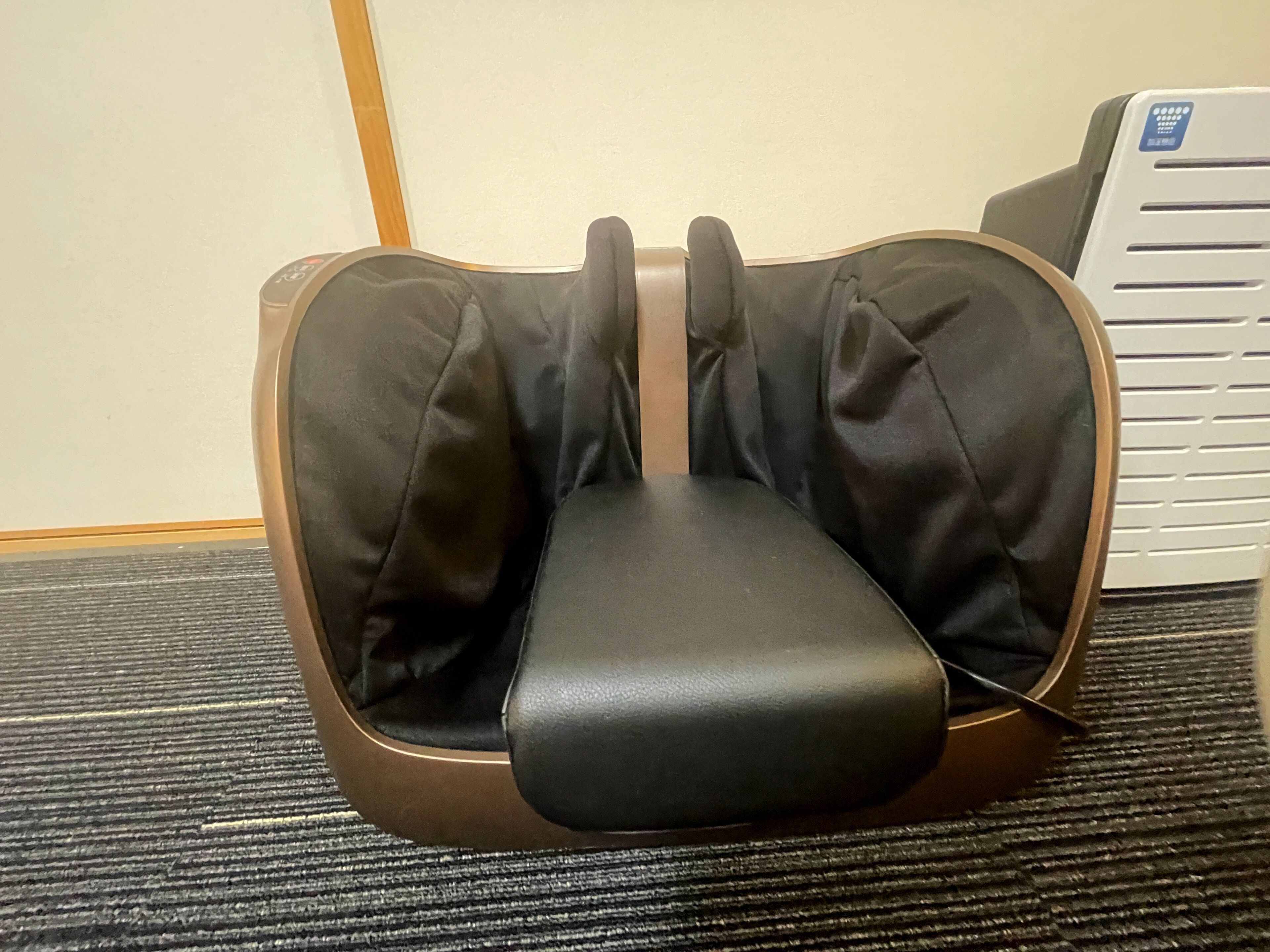 A massage chair with a contoured seat and backrest.