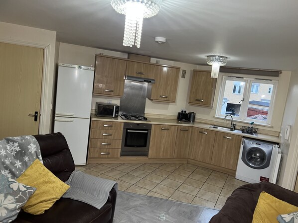 Enjoy cooking in this well-equipped kitchen with a gas stove, oven, and microwave.