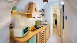 A compact kitchen with a wooden counter, a green toaster, and a sink. - Mystagoge Retreat with subterranean pool/jacuzzi (Vothonas)