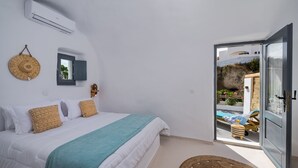 A bedroom with a bed, a window, and a view of an outdoor area with a pool. - Mystagoge Retreat with subterranean pool/jacuzzi (Vothonas)