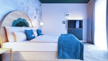Une chambre moderne avec un lit, un téléviseur et un mur orné d’une fresque florale.