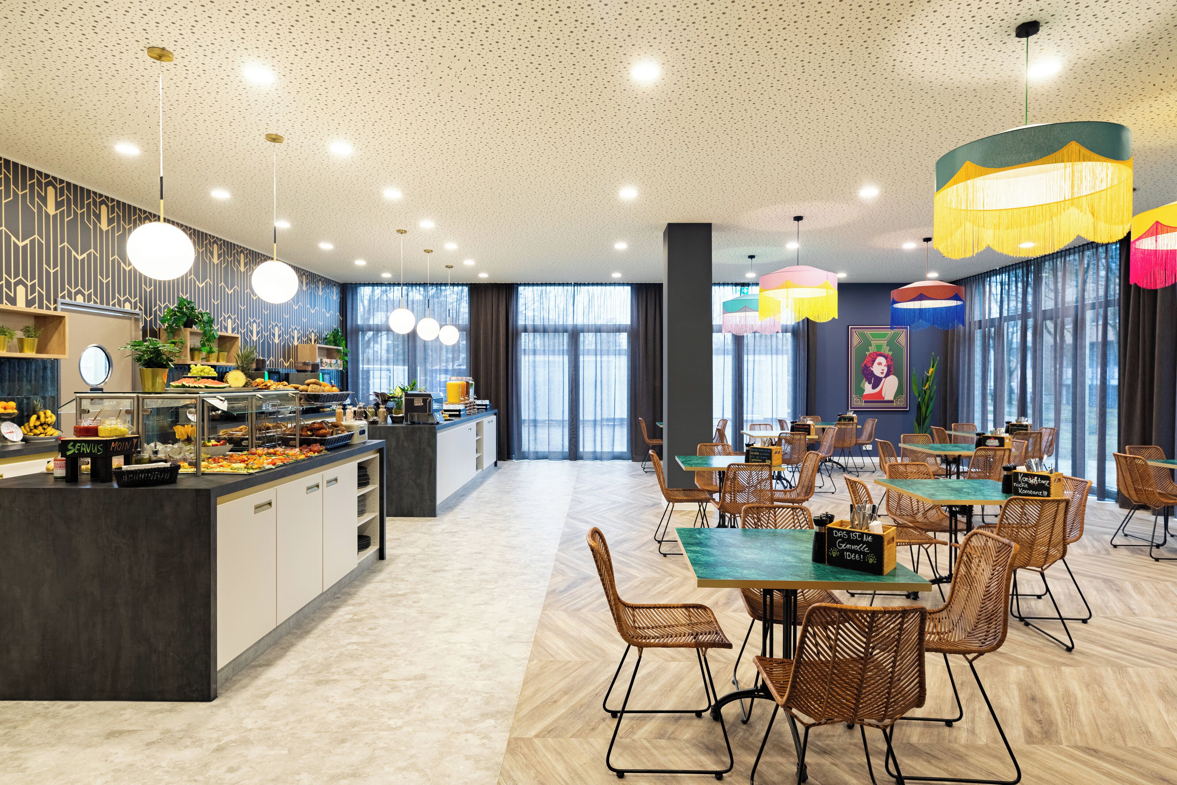 A modern dining area with a buffet, wicker chairs, and pendant lighting.