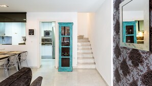 A modern kitchen with a microwave, refrigerator, and a dining area with a bench and chairs. - LR2 PRIVATE TERRACE and parking included. Apartment in the Historic Center (Sevilla)