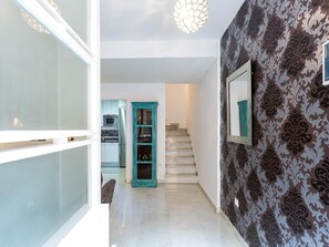 A hallway with a staircase leading to a kitchen area. - LR2 PRIVATE TERRACE and parking included. Apartment in the Historic Center (Sevilla)