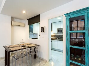 A compact kitchen with white cabinets, a microwave, and a window. - LR2 PRIVATE TERRACE and parking included. Apartment in the Historic Center (Sevilla)