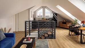 A modern loft apartment with a kitchen, dining area, and living space. - Trevi Apartments Tychy (Tychy)