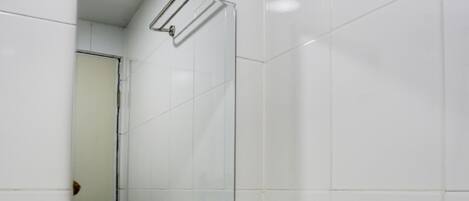 A white bathroom with a sink and a mirror.