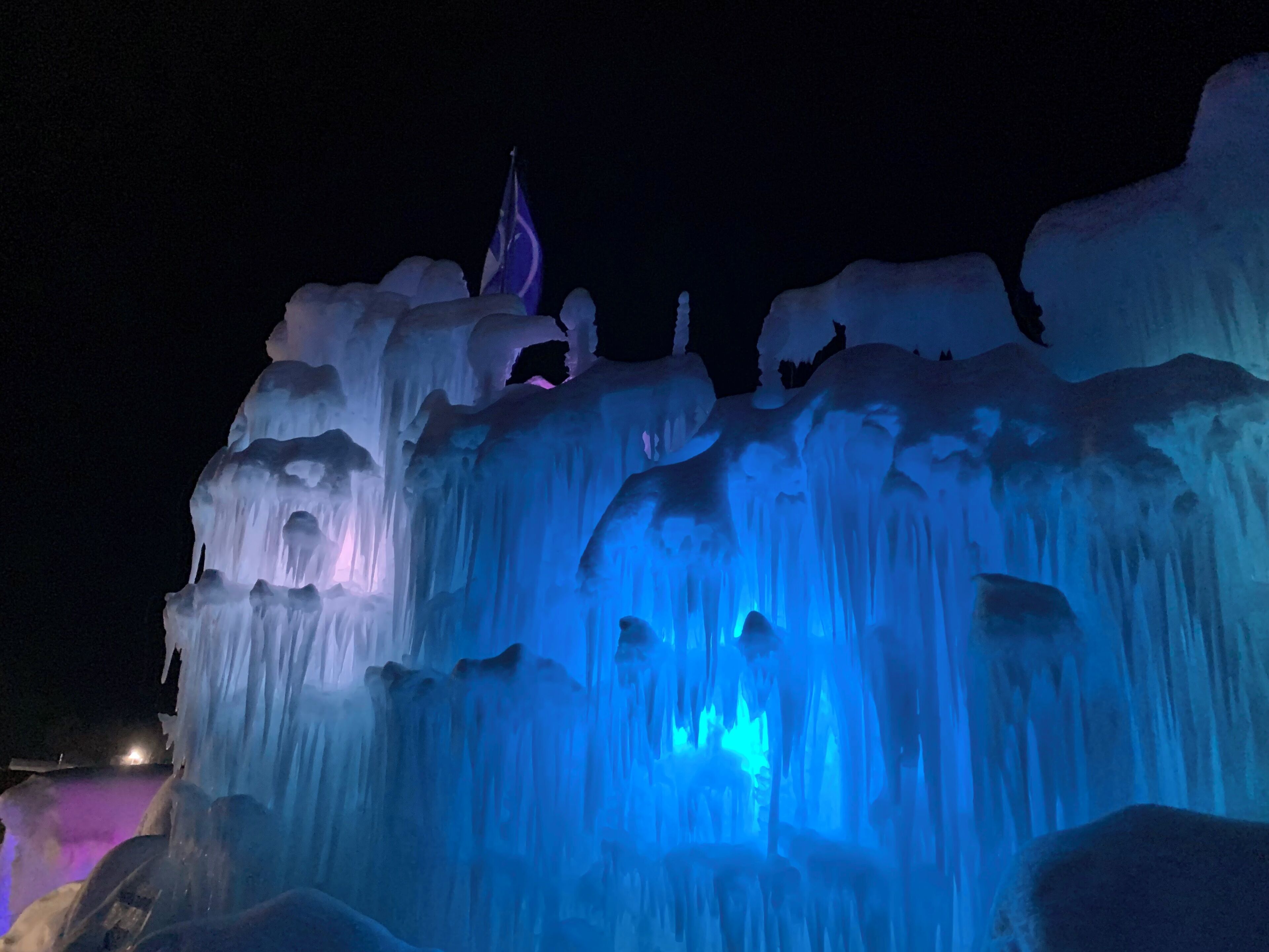 A nighttime view of an ice sculpture with illuminated sections.