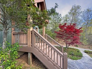 A wooden staircase leading to a building with a green exterior. - Bear Necessities - 2BR, sleeps up to 6, amazing view, hot tub + free Biltmore tix (Sylva)