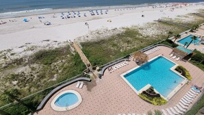 A resort with a large pool area, a beach, and a wooden boardwalk. - WATCH THE DOLPHINS PLAY FROM THE BALCONY! (Orange Beach)