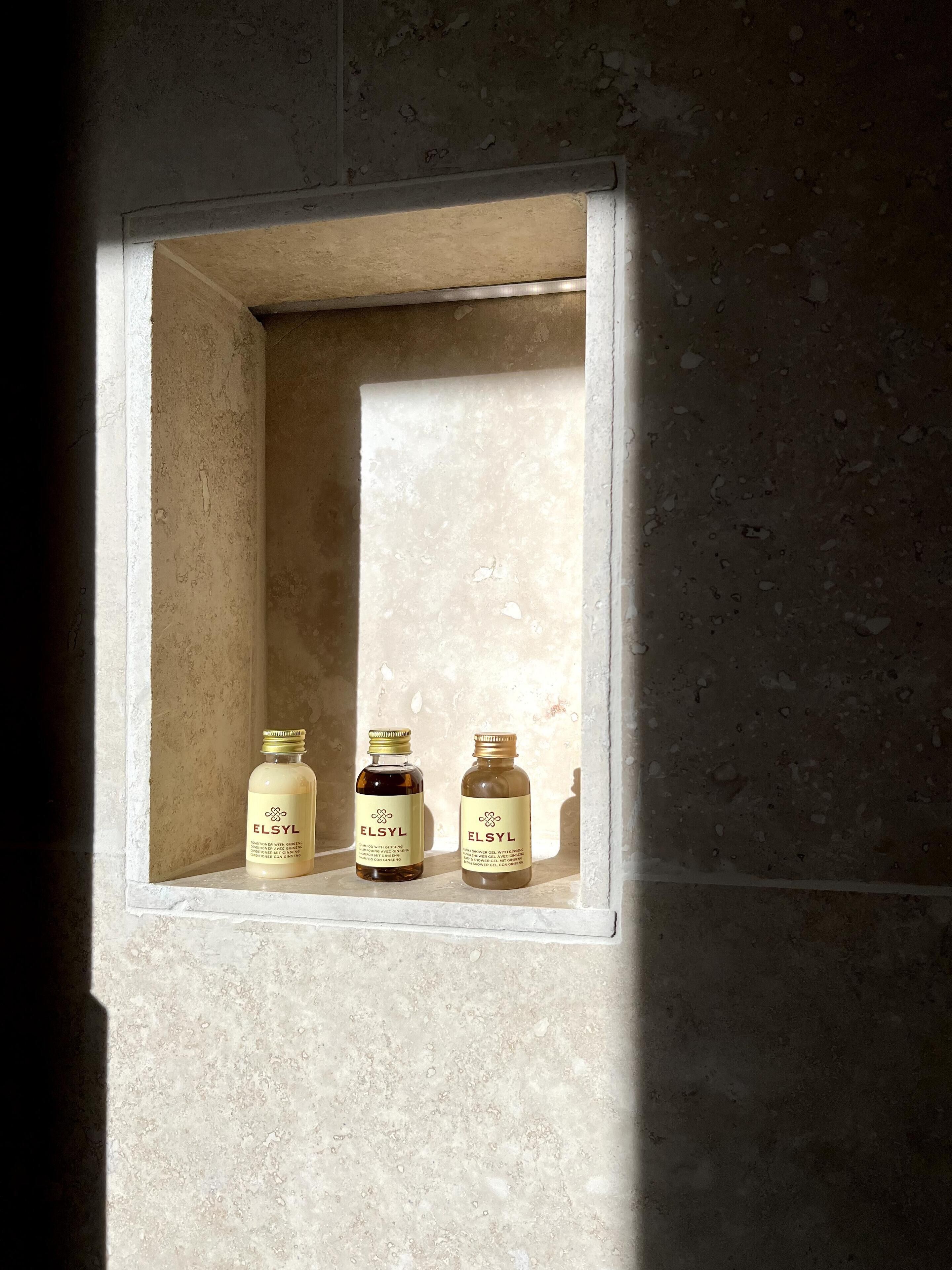 A shelf with three ELSYL products in a well-lit alcove.
