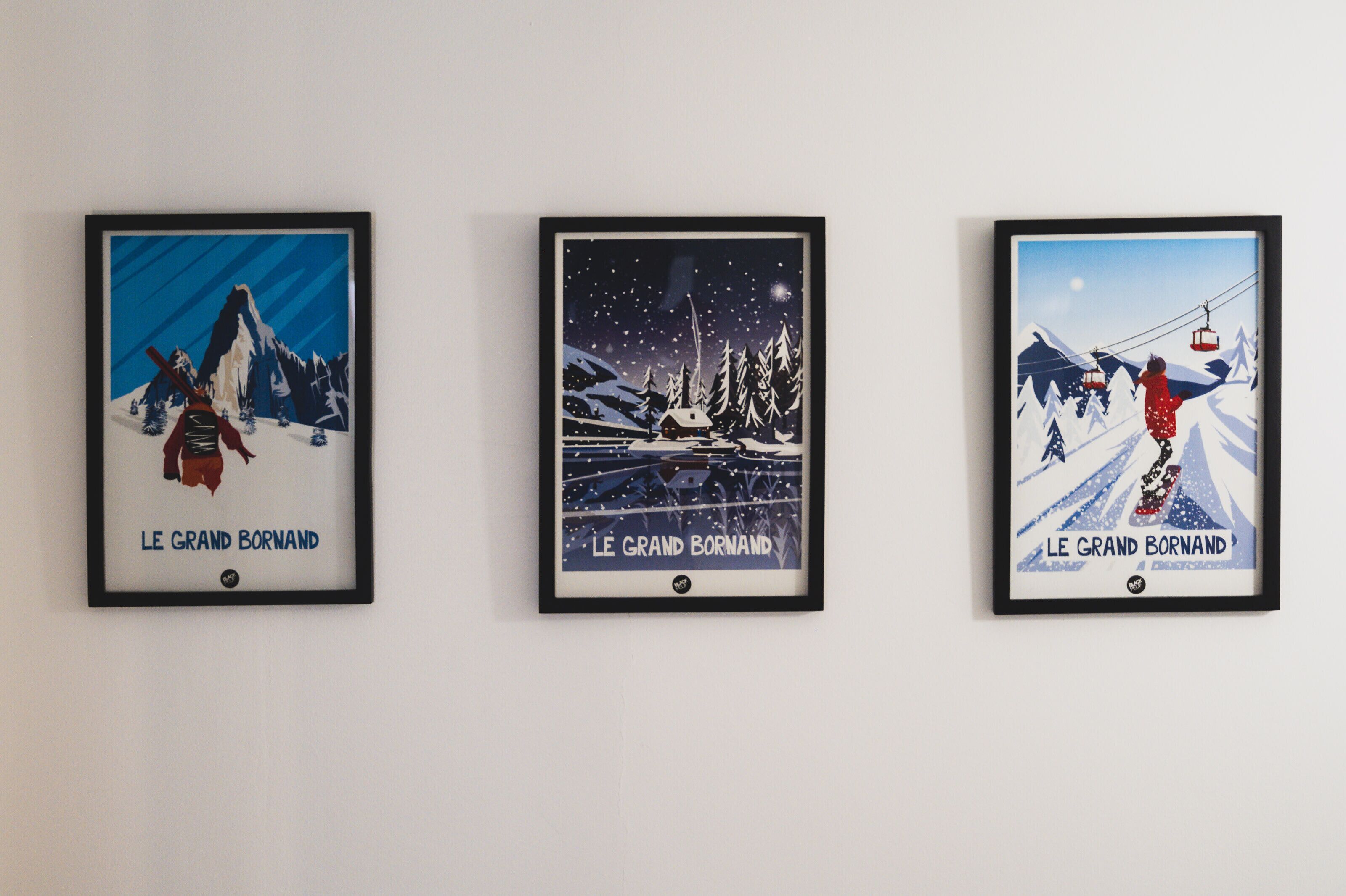 Three framed posters of 'Le Grand Bornand' landscapes.