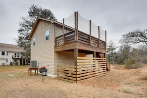 A two-story house with a wooden deck and a covered outdoor area. - Luxury Golf Villa w/ Hot Tub Stunning Golf Course Views Near OBX Beaches (Kitty Hawk)