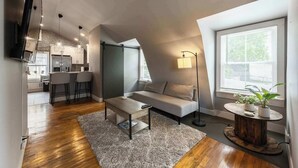 Un apartamento estilo loft con cocina, comedor y una zona de estar acogedora con sofá y mesa de centro.