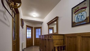 A hallway with wooden paneling, a bench, and a framed picture on the wall. - Harrachov 561 by Interhome (Harrachov)