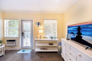 Relax in this inviting living room with a flat-screen TV, console table, and comfortable seating area.