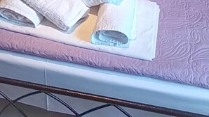 A bed with white linens and pillows, a metal headboard, and a pink bedspread. - Villa Zina Studio 3 Pelion (Zagora-Mouresi)