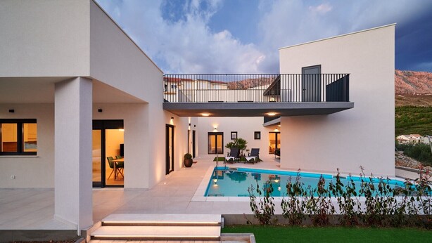 A modern two-story house with a swimming pool, outdoor seating, and a view of the surrounding landscape. - Modern Villa AdriaStar with a swimming pool (Dugi Rat)