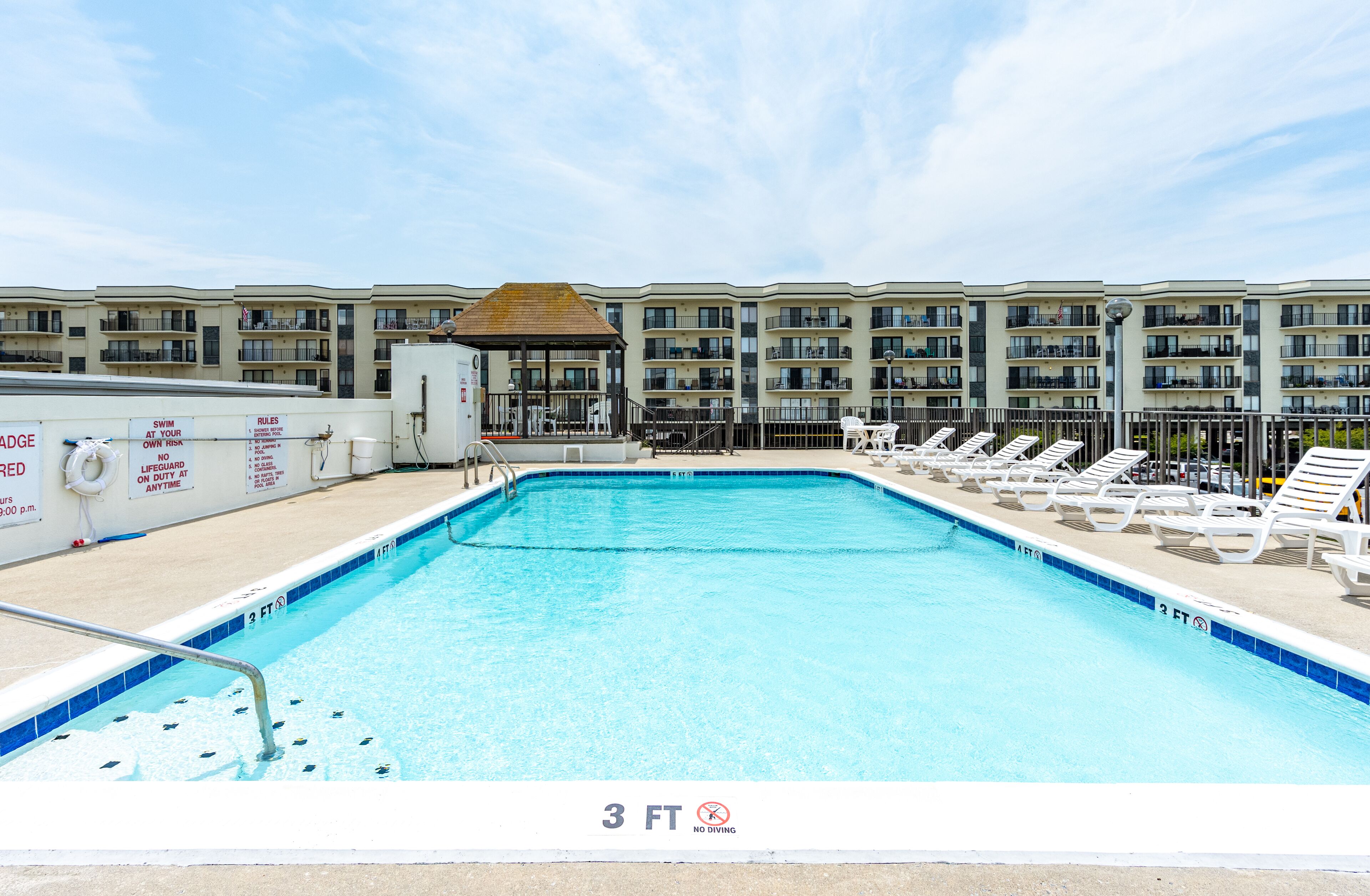 A 3 FT deep indoor swimming pool with lounge chairs and a lifeguard station.