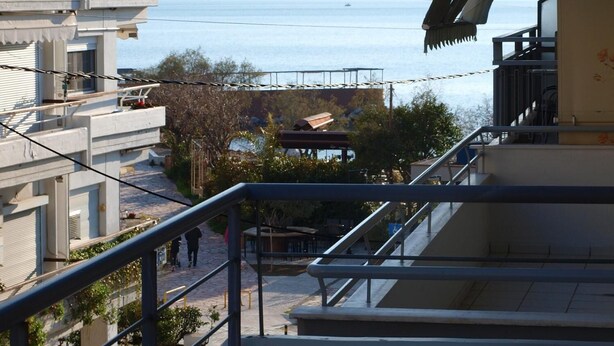 A view from a balcony overlooking a body of water with buildings in the background.