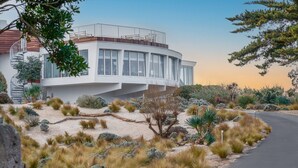 A modern building with a curved facade, large windows, and a spiral staircase. - Le Grand Large  (Dolus-d'Oleron)