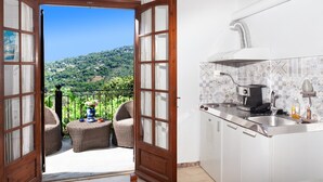 A balcony with wicker furniture and a view of a green hillside. - Paradeisos Double Room With Balcony 2 (Zagora-Mouresi)