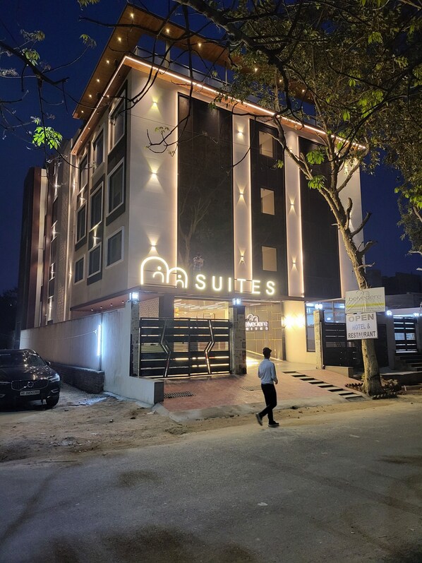 A modern hotel with a sign reading "SUITES" and "BELVEDERE HOTELS & RESTAURANT". - Belvedere Suites- A Boutique Business Expo Hotel (Greater Noida)