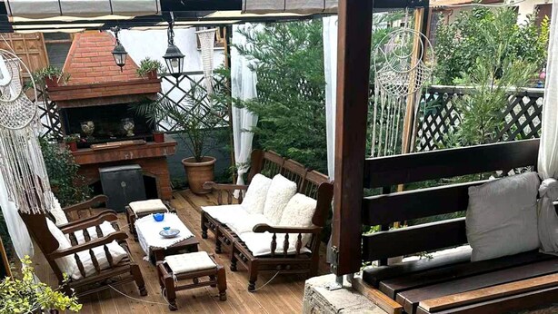 A wooden deck with outdoor furniture, including a sofa, chairs, and a table. - Harmony Platanidia Pelion (Volos)