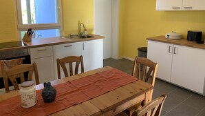 A compact kitchen with a window, sink, and cabinets.