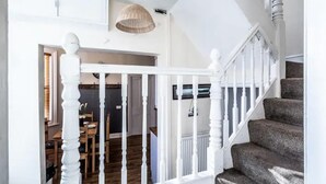 A staircase with white railings and a dark carpeted landing. - The Boat House Sleeps 4 Pet Friendly (Dawlish)