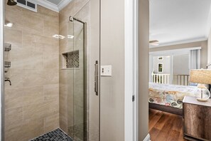 Bathtub, hair dryer, towels, shampoo