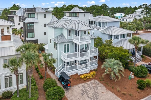 A multi-story house with a balcony, surrounded by palm trees and a driveway. - Spacious Seagrove Escape Cart Bikes Pool Near Beach (Santa Rosa Beach)