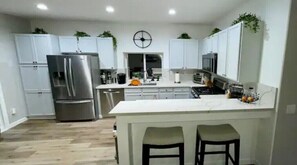Enjoy cooking in this well-equipped kitchen with a central island and bar stools.