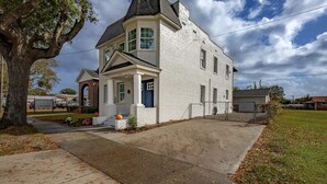 A two-story house with a prominent front porch and a large tree to the left. - Point on Pollock - Brewery Row - Brim of Downtown (New Bern)