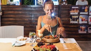 A dining table with a variety of dishes, including a salad, bread, and a dessert. - Far Life Hotel (Konyaalti)