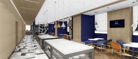 A modern restaurant with a long counter, multiple tables, and a variety of seating options.