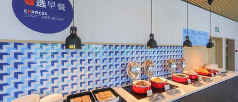Ein Frühstücksbuffet mit verschiedenen Speisen und einem Schild, das es als Frühstücksangebot kennzeichnet.