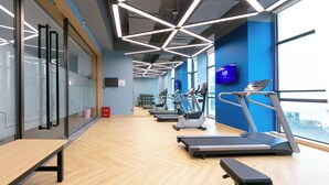 A modern gym with treadmills, a bench, and a wooden floor. - Holiday Inn Express Shanghai Pudong Airport by IHG (Shanghai)