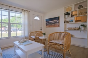 Relax in this inviting room with a large window, a comfortable seating area, and a cozy reading nook.