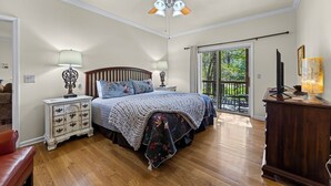 A bedroom with a bed, nightstands, a dresser, a ceiling fan, and a balcony with a view. - Condo w/ Creek, Golf & Mtn Views, Only 5 Steps to get in and Washer & Dryer! (Whittier)