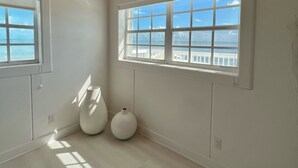 A spacious room with large windows, a wooden ceiling, and a light-colored floor. - Your favorite getaway place (Bimini)