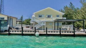 A two-story house with a balcony, a covered patio, and a pool. - Your favorite getaway place (Bimini)
