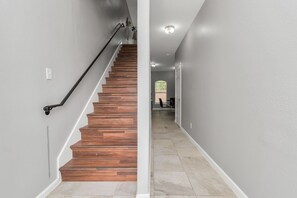 Staircase leading to an upper floor with a door and window.