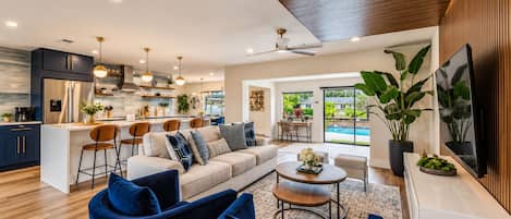 A modern living space with a kitchen, dining area, and seating area.