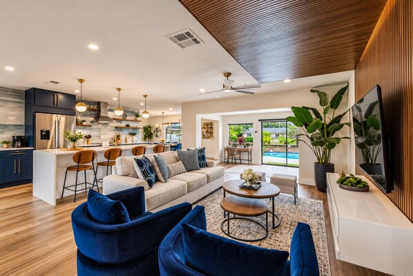 A modern living space with a kitchen, dining area, and seating area.